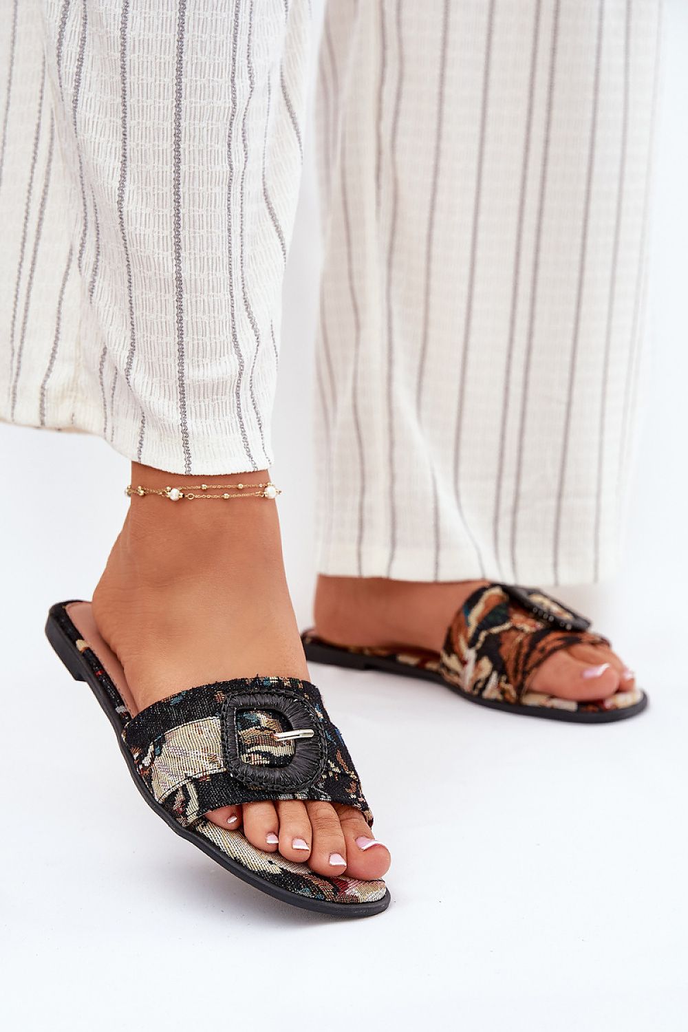 Step in Style women's stylish flat sandals with a decorative front buckle, ideal for everyday summer wear.