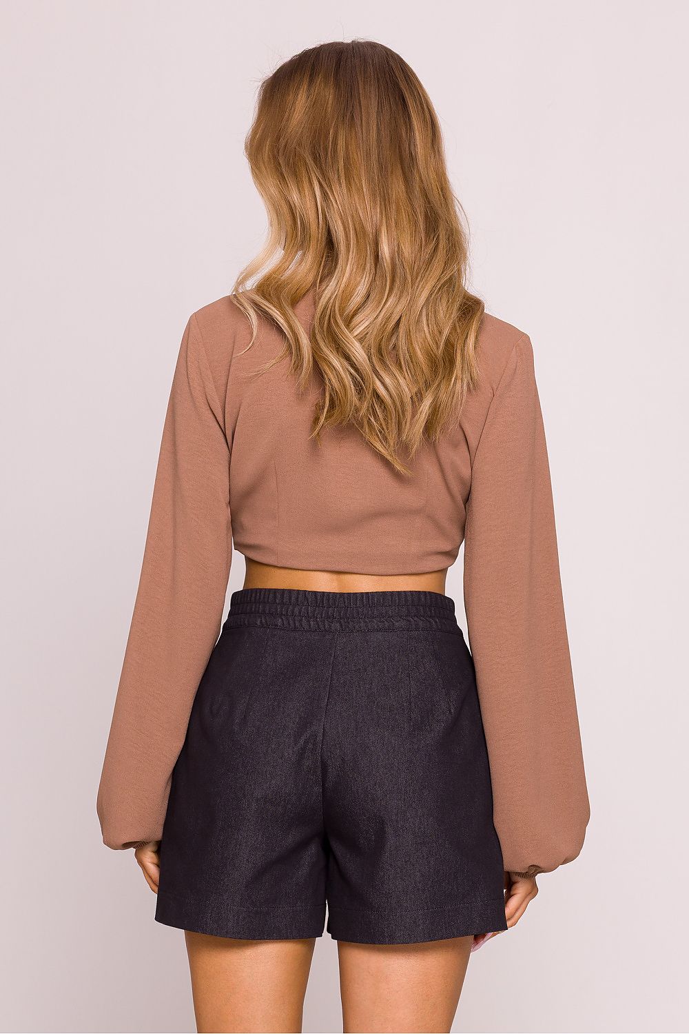 Close-up view of high-waisted cotton shorts with decorative pleats by Moe, showcasing the exquisite fabric texture and fine detailing.