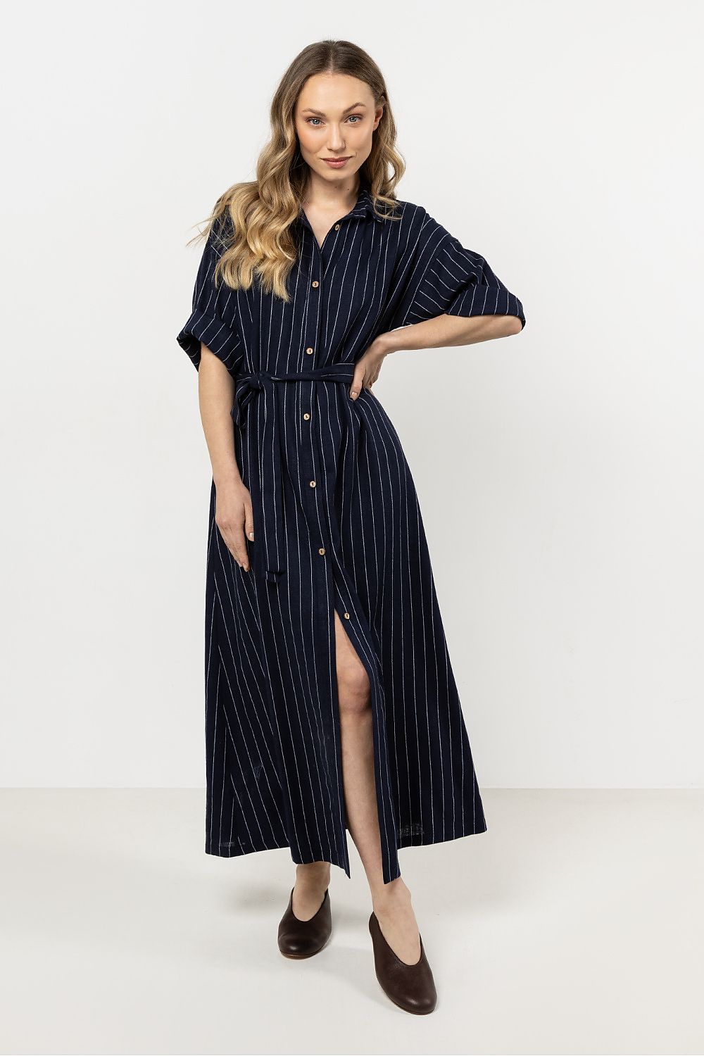 Elegant linen shirtdress in stripes by awama, showcasing a comfortable trapeze cut and stylish stand-up collar for a luxurious look.