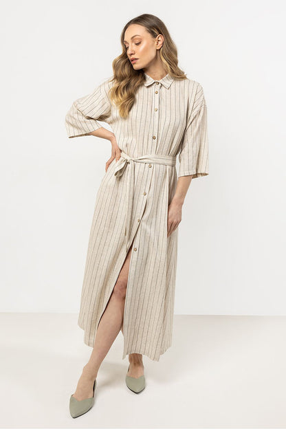 Model wearing the elegant linen shirtdress in stripes by awama, illustrating its stylish silhouette and versatility for any occasion.