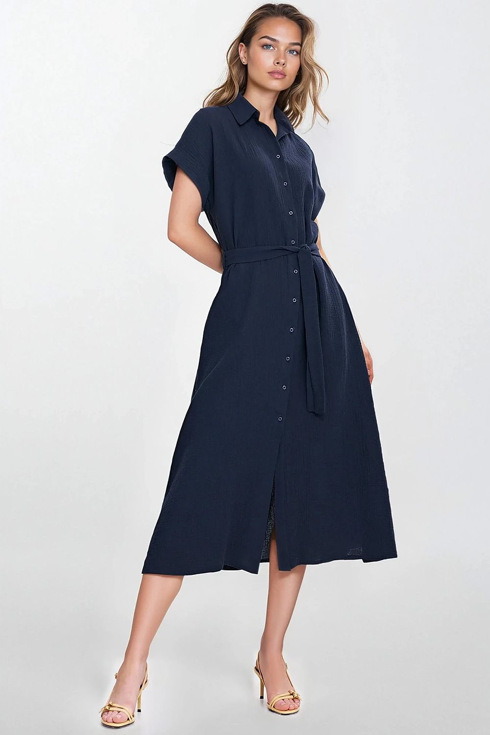 Elegant Relaxed Fit Daydress by Nife, showcased in a serene setting, featuring a lightweight linen-blend fabric that's perfect for summer days.