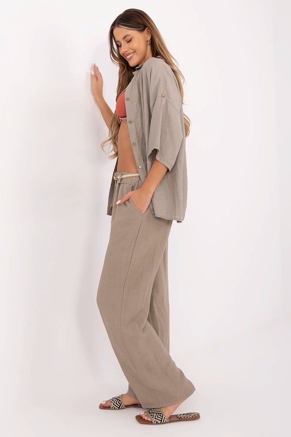 Italy Moda Women's Boho Trousers artfully styled with a light blouse, emphasising the versatile high-waisted wide leg fit for casual elegance.