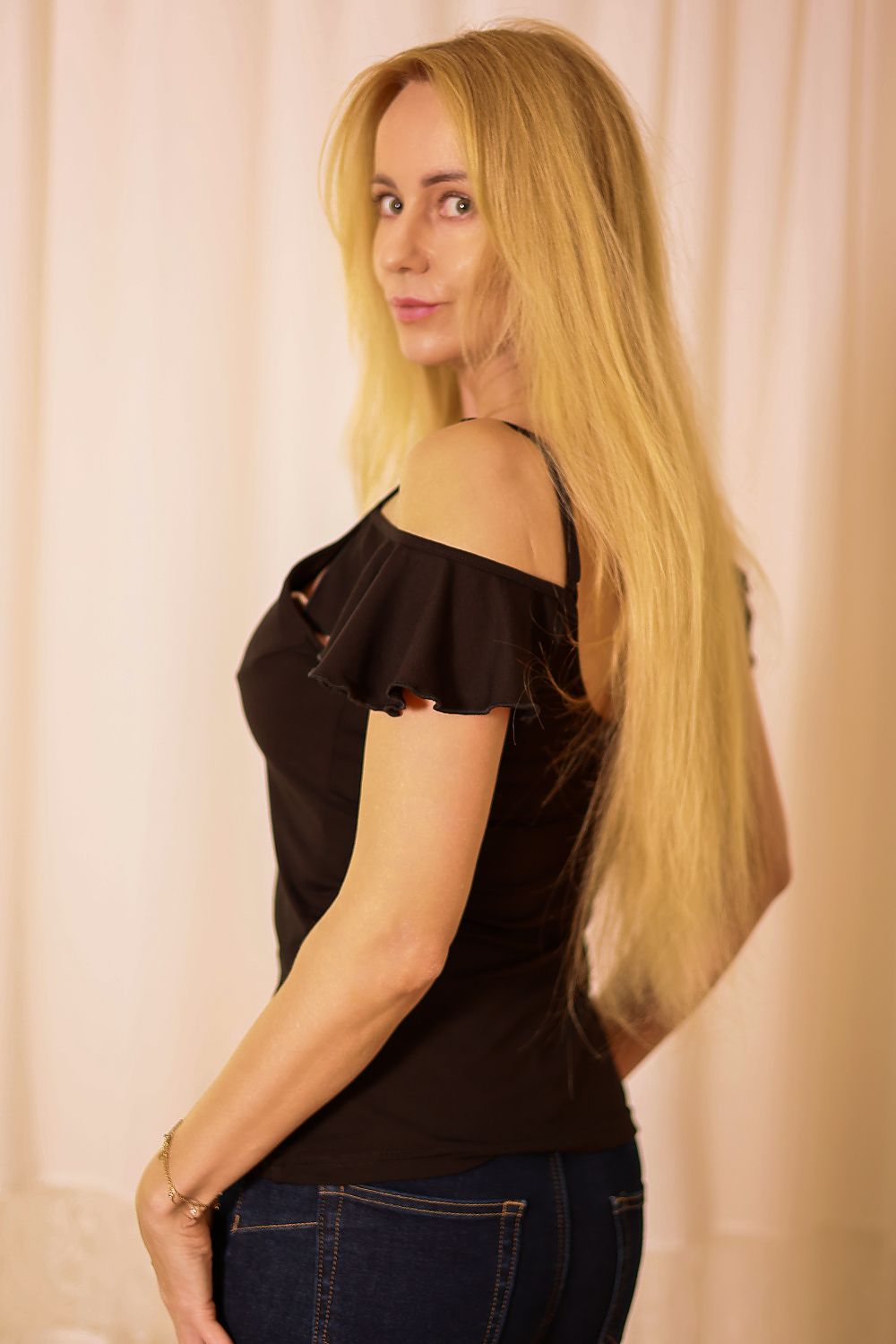 Mirale Vera Blouse styled with denim shorts, illustrating its versatile and chic summer fashion possibilities.