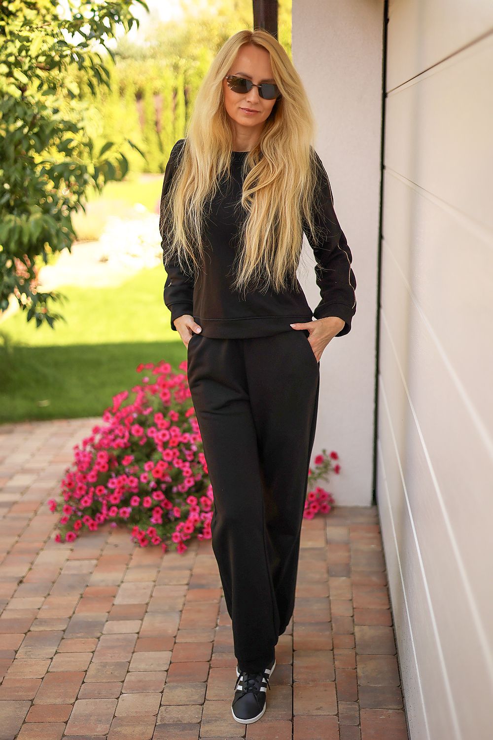 Mirale Maio tracksuit set laid out to show the comfortable cotton blend fabric and chic gold trim embellishments.