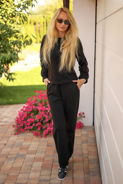Mirale Maio tracksuit set laid out to show the comfortable cotton blend fabric and chic gold trim embellishments.