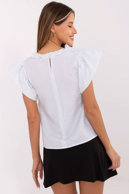 Side view of the elegant polka dot blouse by Lakerta featuring short frill sleeves, demonstrating its graceful silhouette suitable for both formal and everyday office outfits.
