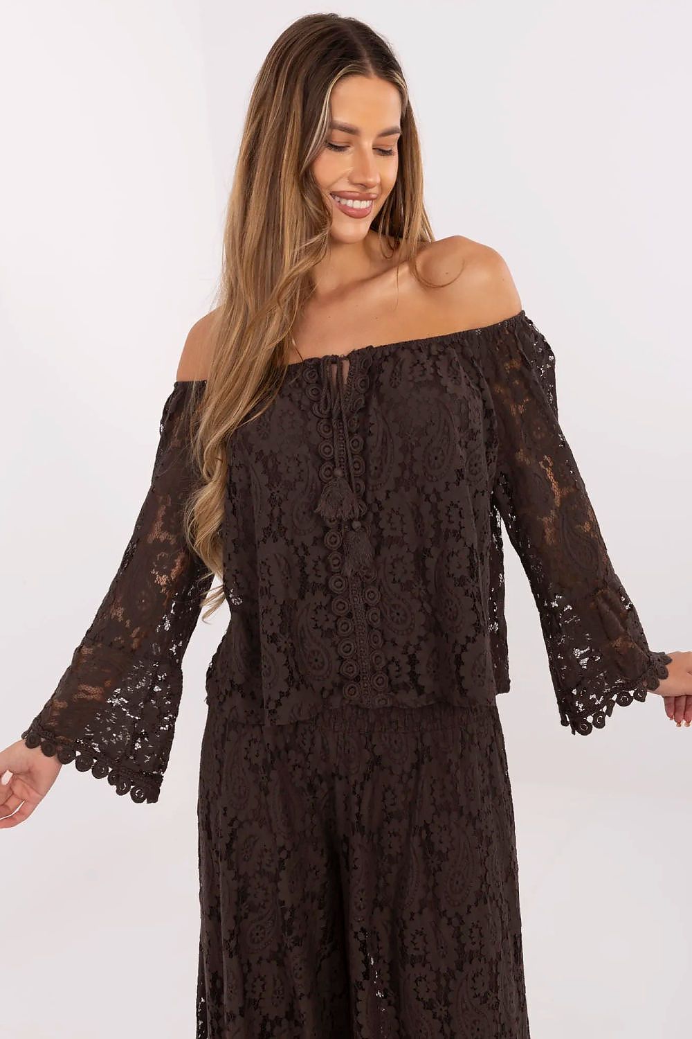 Model wearing the Italy Moda Elegant Lace Blouse with Spanish Neckline, perfectly styled with tailored trousers, ideal for formal occasions.