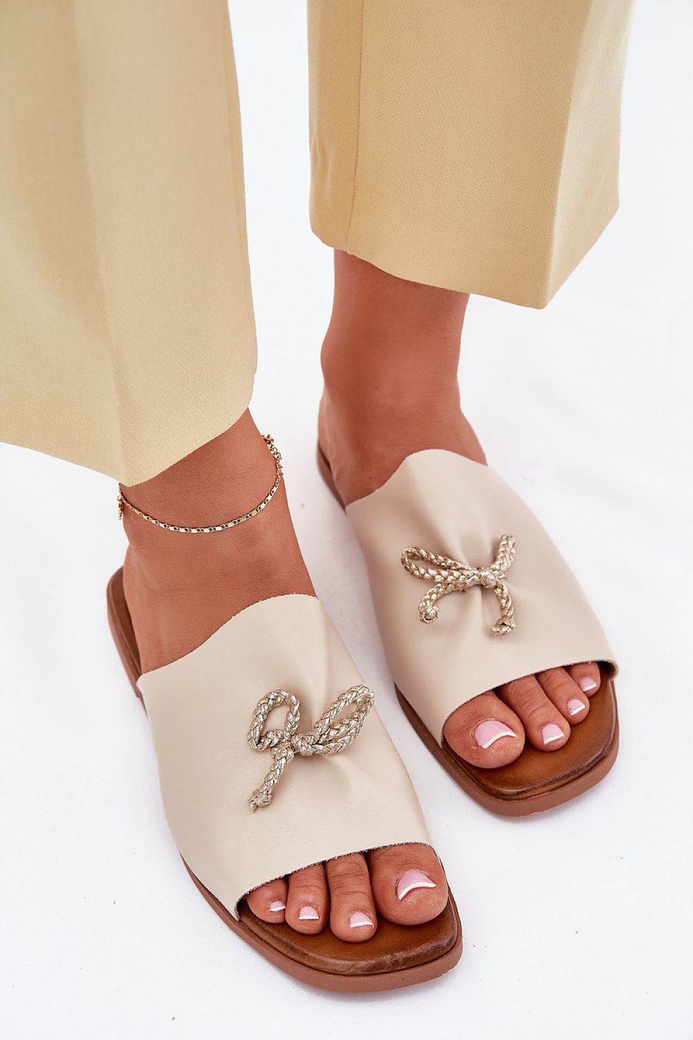 Elegant women's eco leather sandals with decorative lacing by Step in style, showcasing a chic flat heel design.