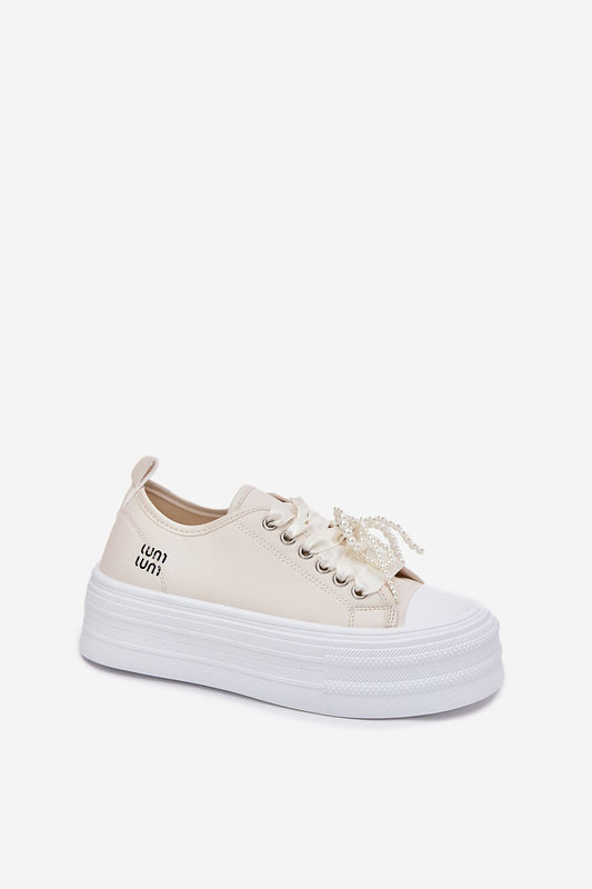 Close-up of chic women's eco leather sneakers from Step in Style, showcasing decorative pearl accents and superior comfort.