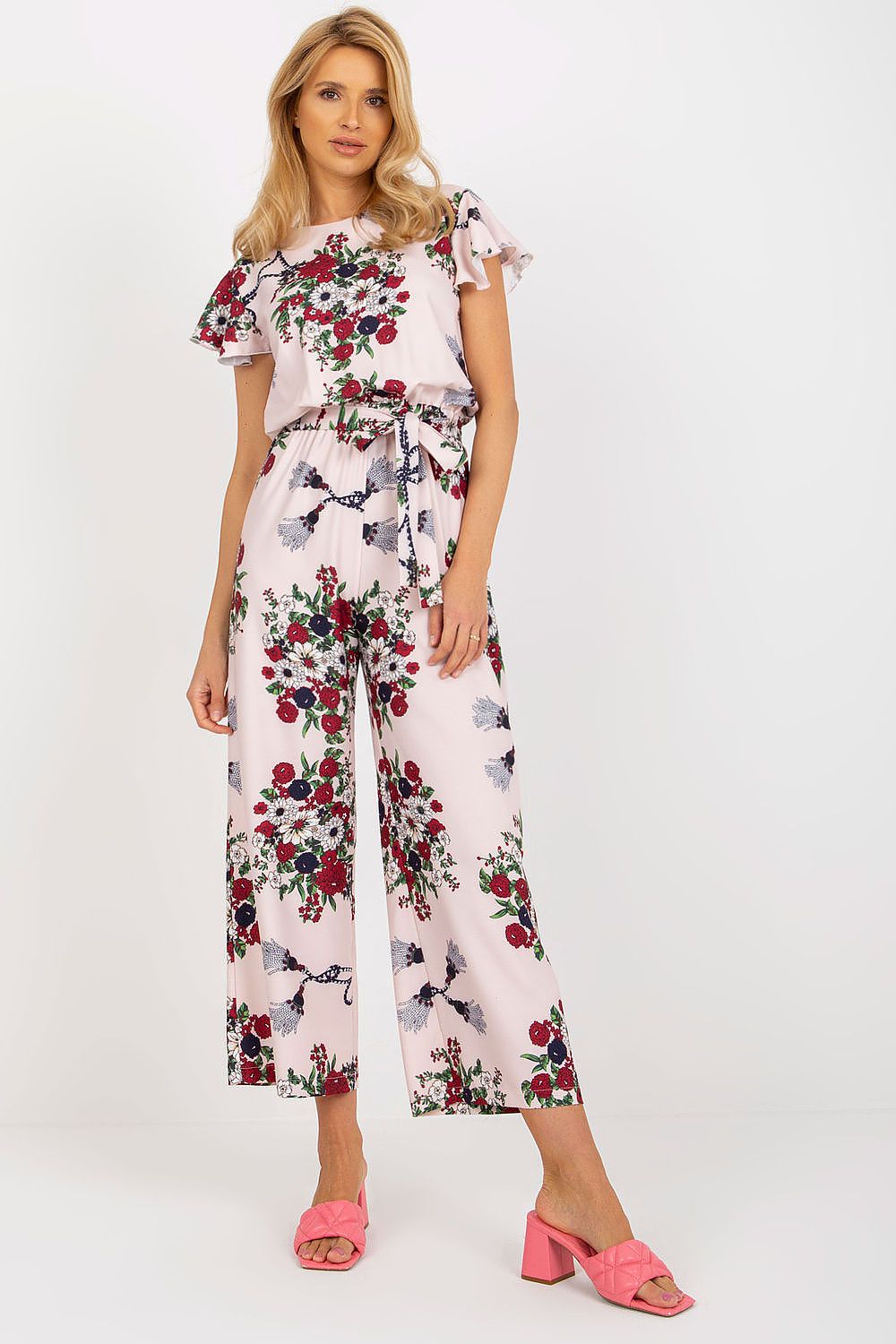 Elegant floral cotton jumpsuit from Lakerta featuring ruffled sleeves, perfect for summer outings, accentuating the waist for a flattering silhouette in sizes EU 36-42 / US 4-10.
