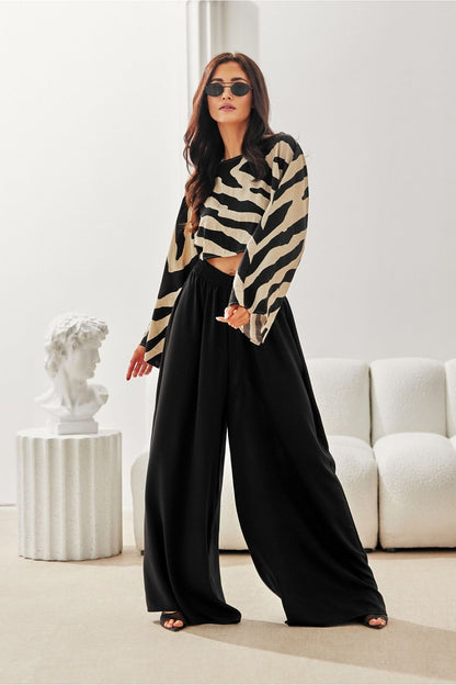 Luxurious summer outfit featuring Lara Wide Leg Trousers by Roco Fashion, highlighting their comfortable fit, stylish wide leg design, and practical pockets, ideal for city and vacation wear.