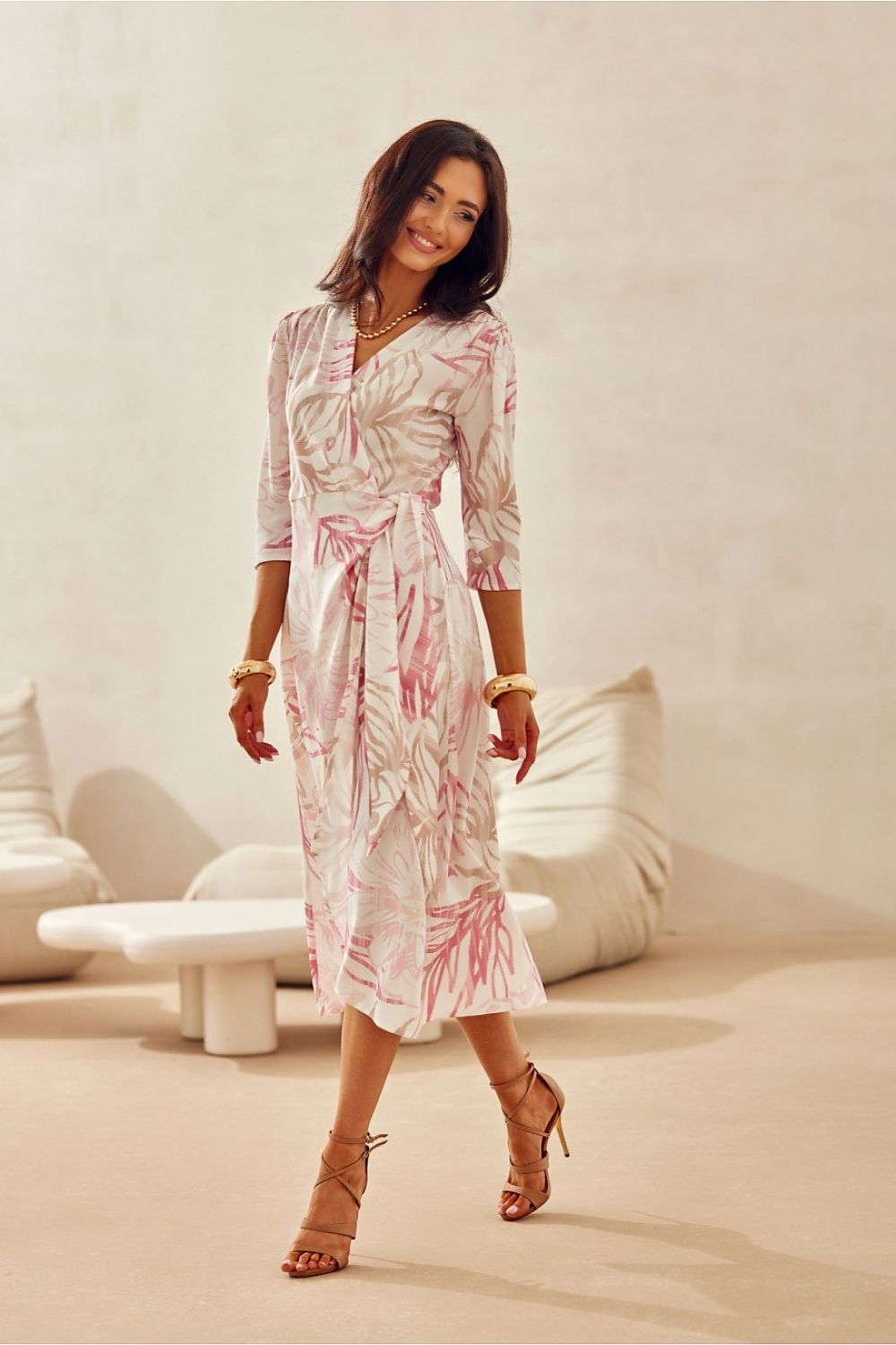 Woman styling the Mirella Midi Dress by Roco Fashion at a wedding reception, highlighting its elegant silhouette.