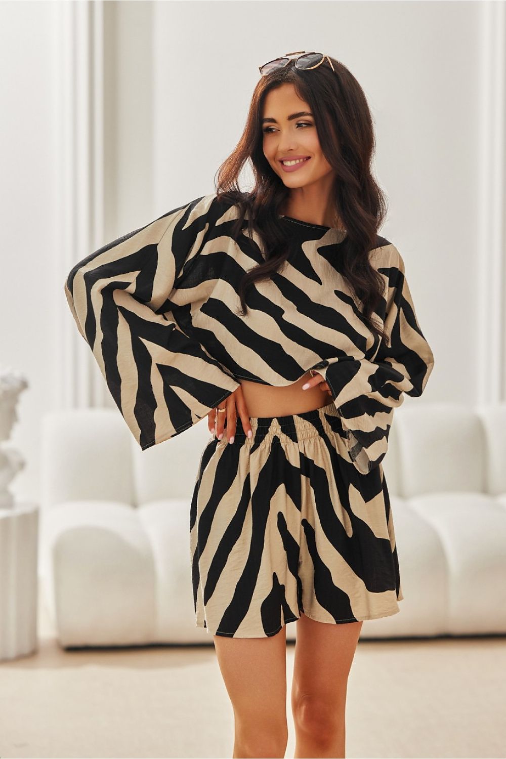 Model wearing the Bianca Roco Fashion Blouse from Roco Fashion, radiating summer style with wide sleeves and a gentle round neckline.