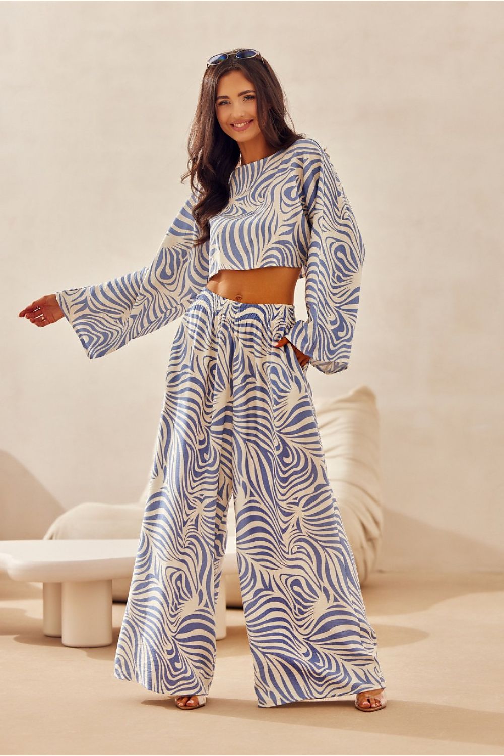 The elegant Bianca Roco Fashion Blouse by Roco Fashion displayed on a hanger, exemplifying sophisticated summer apparel in a chic, loose fit.