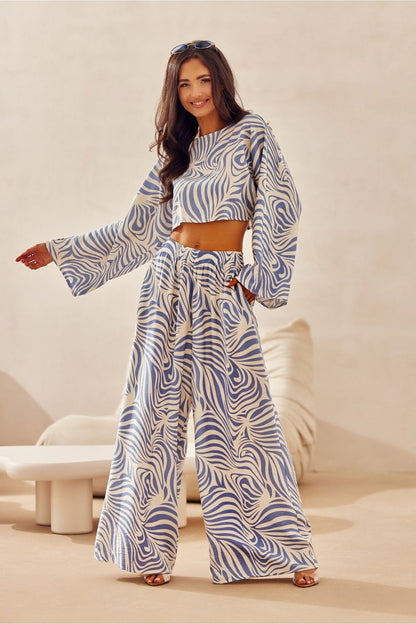 The elegant Bianca Roco Fashion Blouse by Roco Fashion displayed on a hanger, exemplifying sophisticated summer apparel in a chic, loose fit.