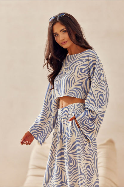 Close-up of the Bianca Roco Fashion blouse featuring gentle, round neckline and wide sleeves, exuding casual charm and luxurious comfort for warm weather.