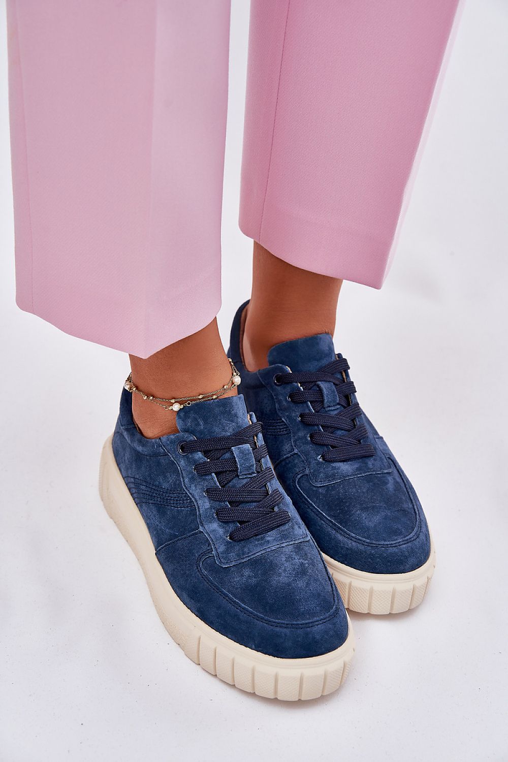 Luxurious Women's Suede Sneakers on a stylish model, demonstrating the perfect blend of sophistication and comfort by Step in Style.