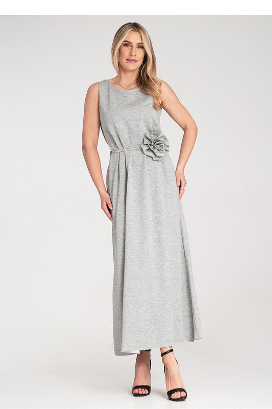 Elegant Figl maxi dress with sleeveless design, featuring a rounded neckline, delicate flower accents, and a cinched waist belt for a luxurious look.