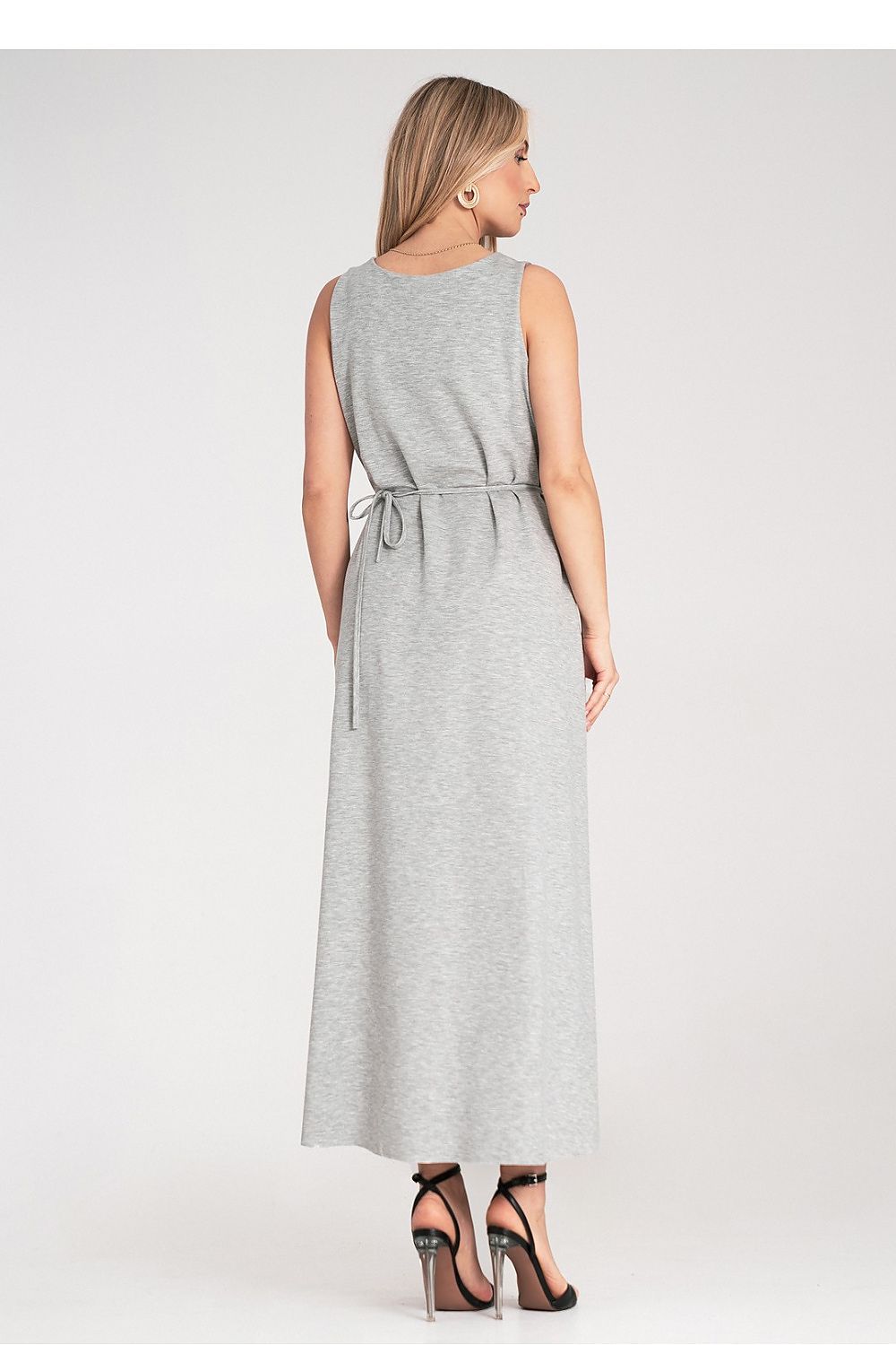 Elegant maxi dress by Figl featuring a sleeveless design, rounded neckline, and floral belt accent in luxurious fabric.