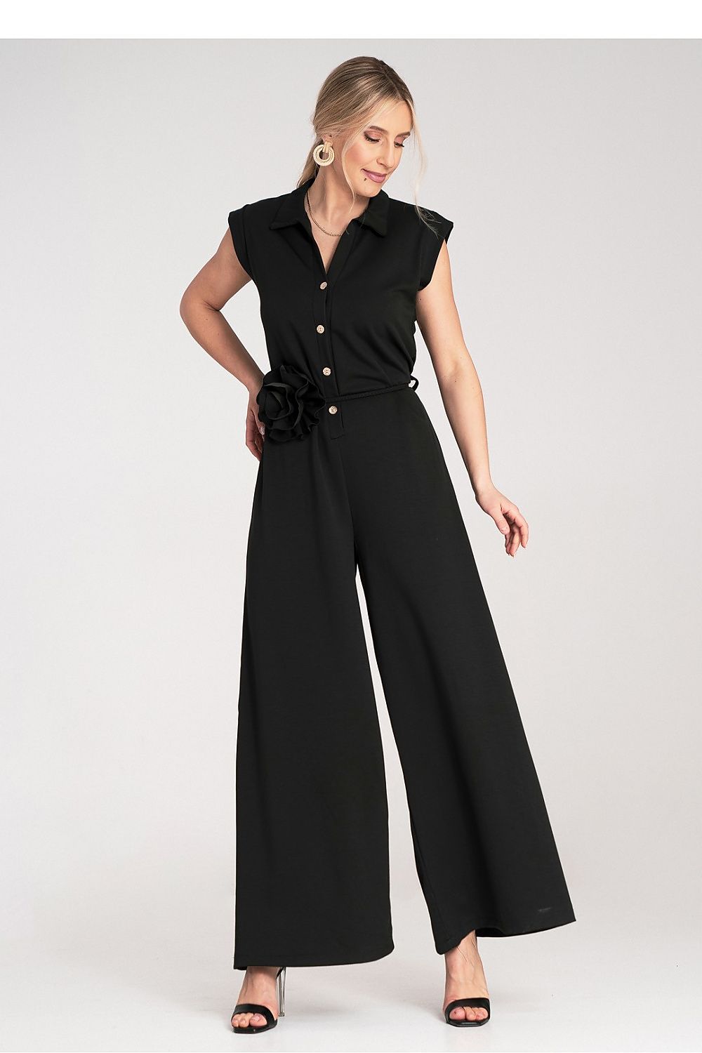 Close-up of Figl's luxury jumpsuit with a stylish belt and delicate flower detail, perfect for chic occasions.