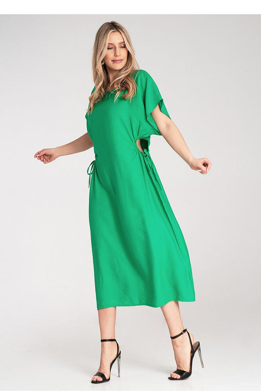 Close-up of the Luxury Figl Midi Dress, highlighting the exquisite fabric and intricate decorative cut-outs that enhance its charm.