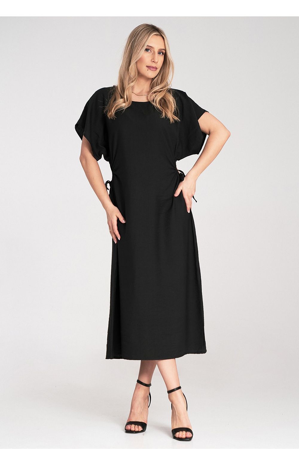 Close-up of the luxurious Figl midi dress showcasing the unique side gatherings and decorative cut-outs for a chic look.