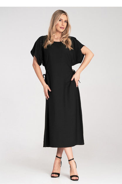 Close-up of the luxurious Figl midi dress showcasing the unique side gatherings and decorative cut-outs for a chic look.