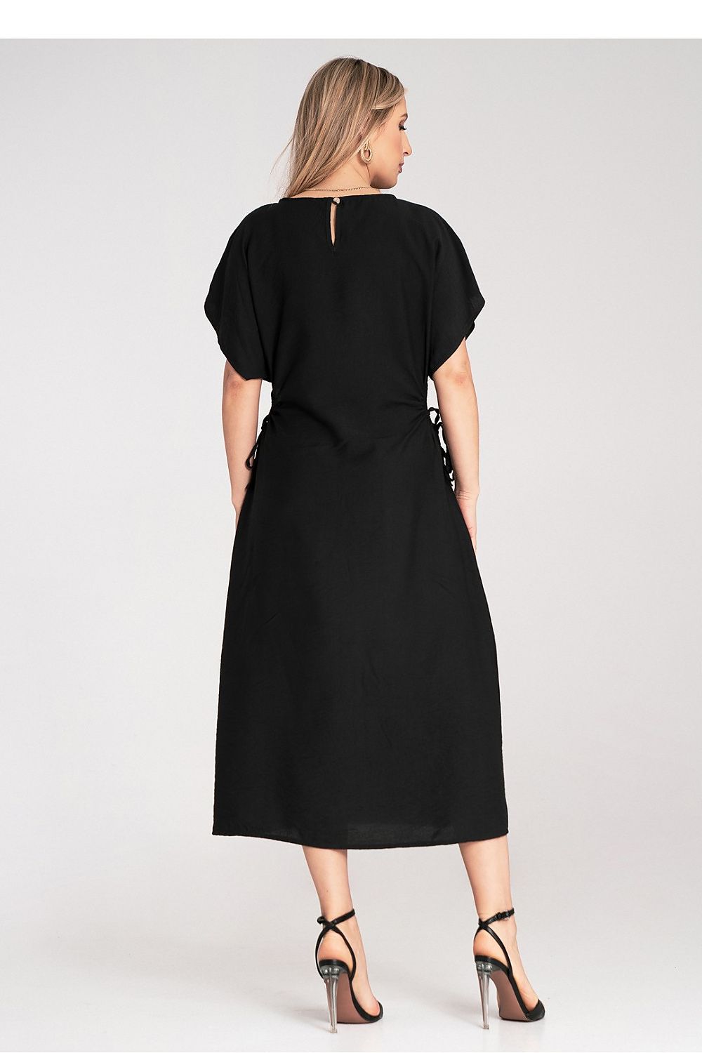 Side view of the luxury Figl midi dress, demonstrating the intricate details of the decorative cut-outs and elegant round neckline.