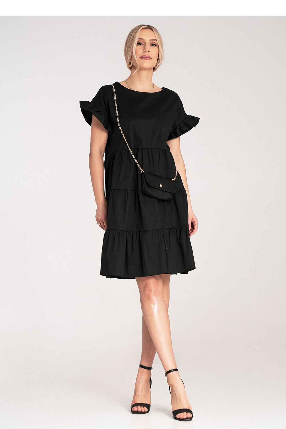 Figl Mini Ruffle Daydress accessorised with a matching small bag on a gold chain, a luxurious addition to the summer wardrobe.