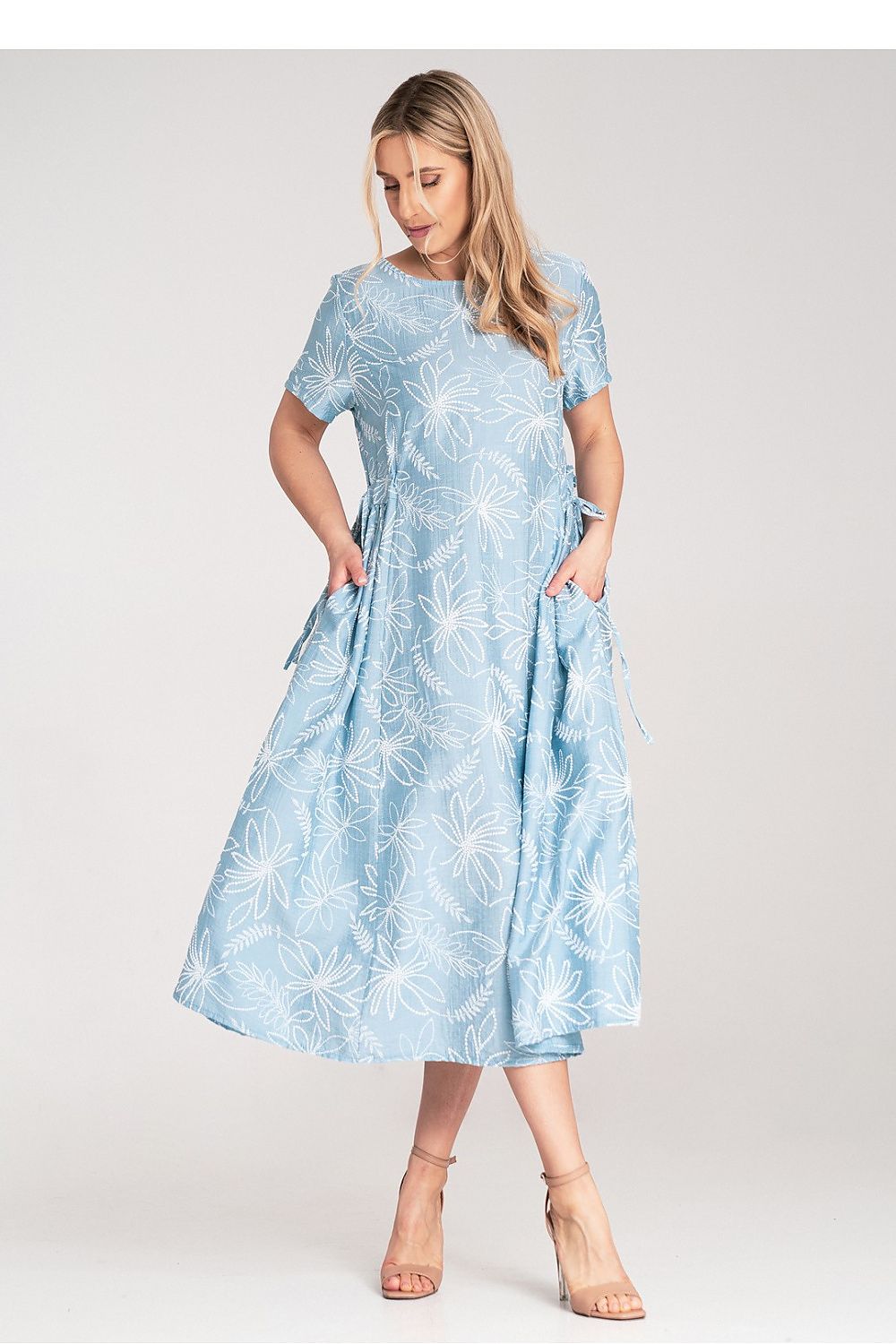 Chic Figl midi dress featuring a white embossed floral design, short sleeves, and practical pockets, emphasising sophistication and style.