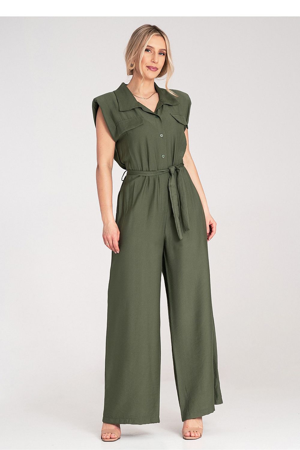 Elegant and trendy Figl jumpsuit featuring padded shoulders and a chic tied belt, ideal for sophisticated evening wear.