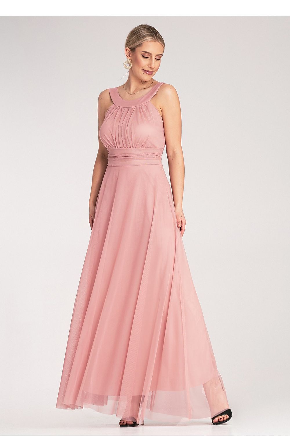 Model wearing the Figl elegant maxi dress in a serene setting, showcasing its flattering high neckline and elegant flow.