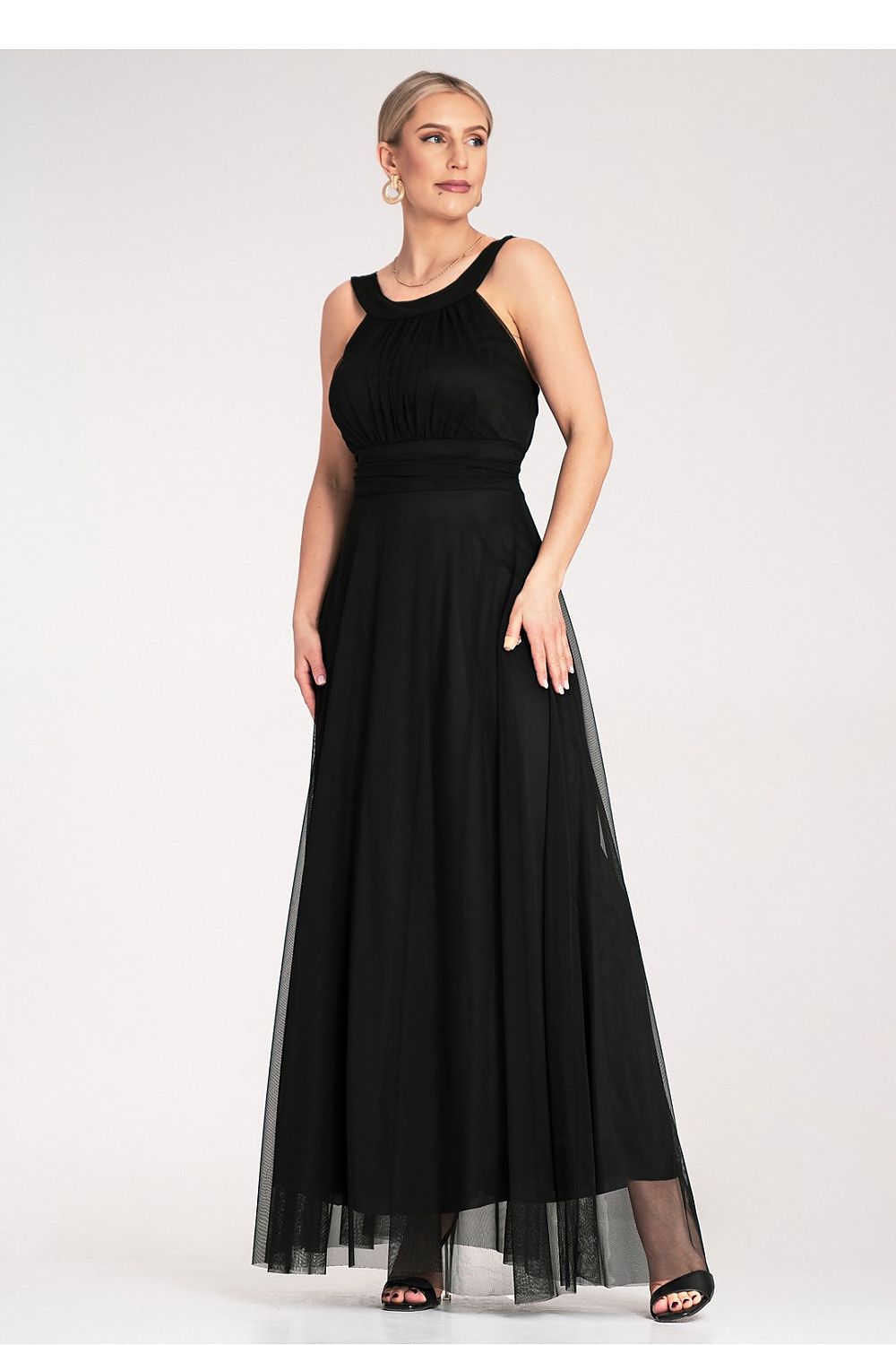 Model wearing the elegant Figl maxi dress with a high neckline and flowing silhouette, ideal for fashionable evening events.