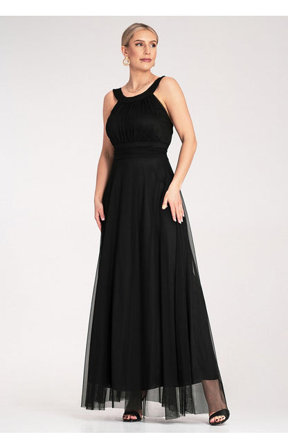 Model wearing the elegant Figl maxi dress with a high neckline and flowing silhouette, ideal for fashionable evening events.