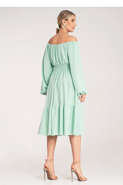 Elegant Figl midi dress modelled on a mannequin highlighting the beautiful design and rich details of the ruched top and Spanish neckline.