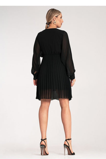 The flared bottom of the Figl luxury mini dress highlighted in a graceful pleat design, exemplifying elegance and sophistication for special occasions.