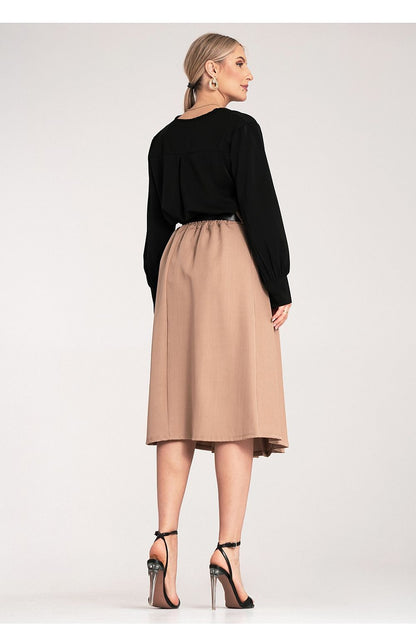 Close-up of the stylish black belt with buckle on an elegant pleated skirt designed by Figl.