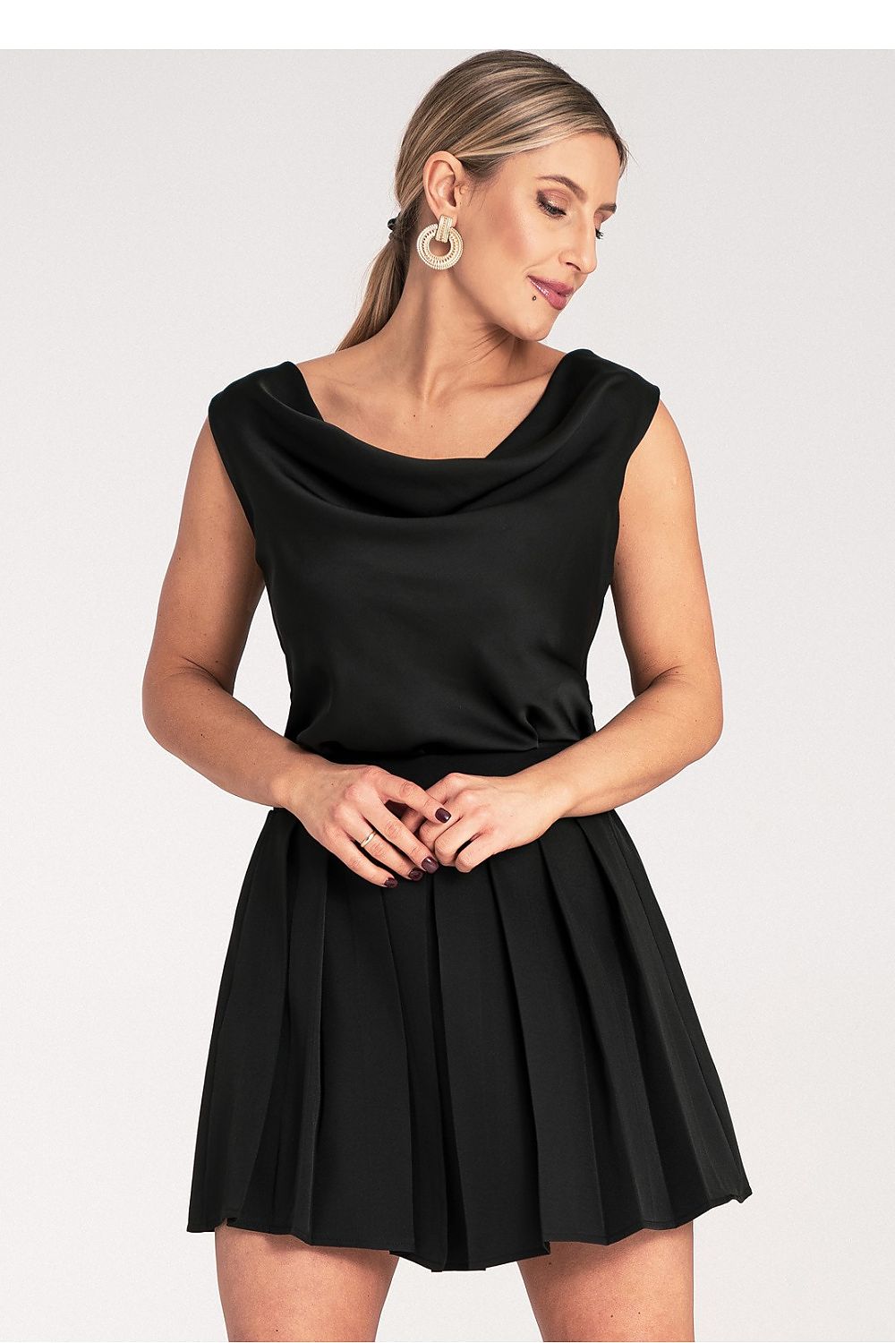 Close-up of Figl's elegant pleated mini skirt showcasing the premium fabric and elastic waistband, tailored for a stylish fit, size EU S/M | US S/M.