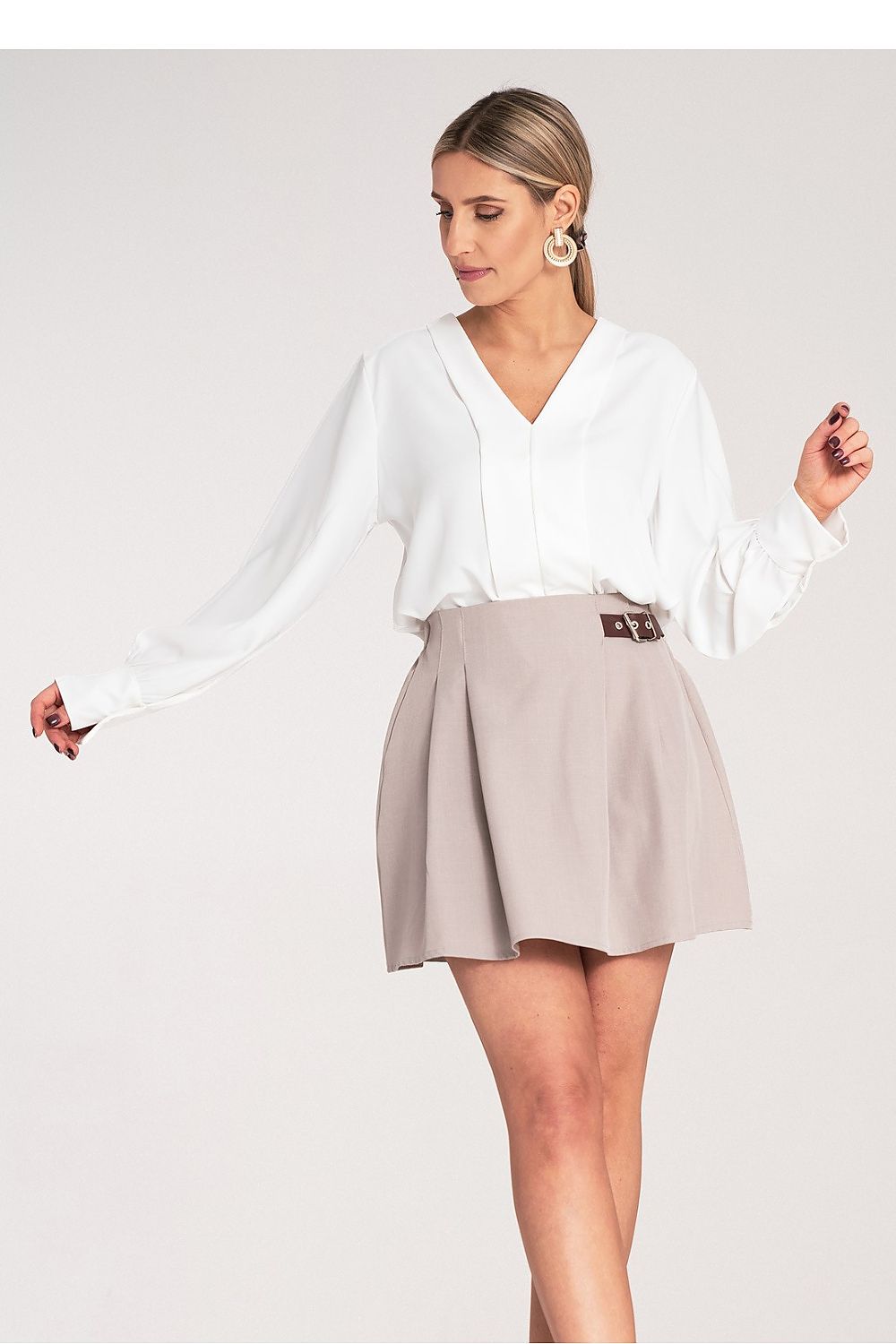 Elegant Women's Mini Skirt by Figl displayed on a model, highlighting its flattering fit and luxurious fabric.