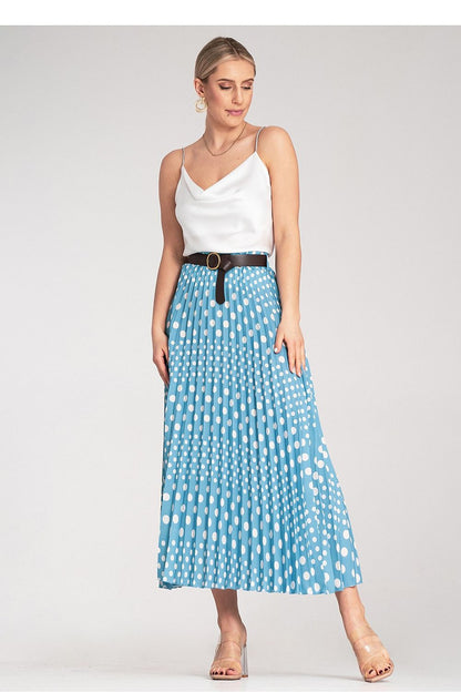 Model wearing Figl's elegant pleated midi skirt with white polka dots, styled for formal occasions, emphasising the high-waisted design and overall luxurious appeal.