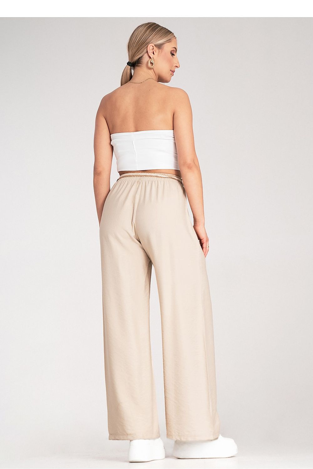 Model wearing luxury Boho trousers by Figl in a natural shade, highlighting the flowy design and comfort.