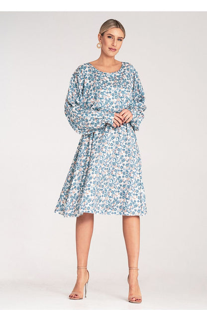 Model wearing the luxury floral midi dress by Figl in a picturesque outdoor setting, accentuating its sophisticated design and flattering fit.