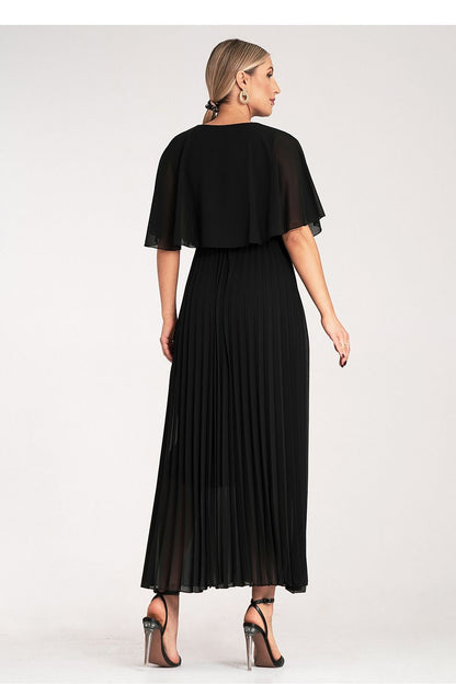 The luxurious Figl maxi cocktail dress displayed on a model, highlighting the flowing cape sleeves and stylish pleated bottom.