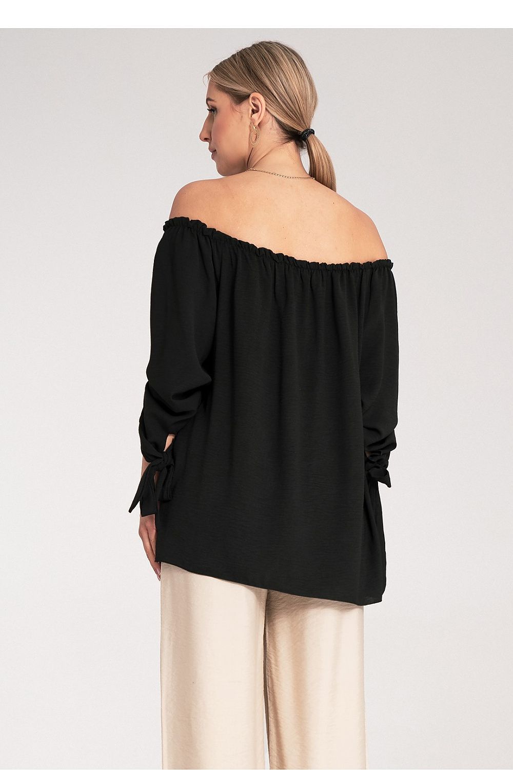 Sophisticated Figl blouse with stylish pleated neckline and shoulder exposure, ideal for fashionable women seeking elegance.