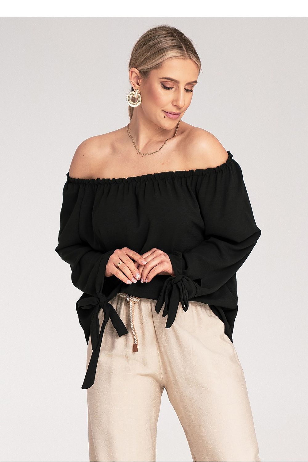 Elegant Figl blouse featuring exposed shoulders and decorative lacing, showcasing luxury fashion style.