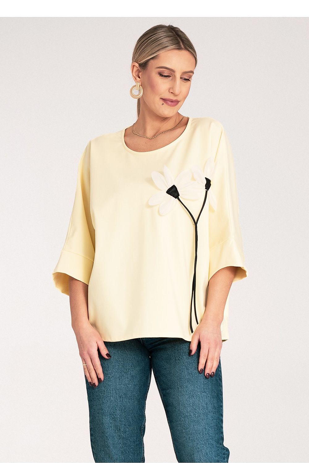 Close-up of the decorative flower detail on the chest of the luxury kimono blouse by Figl, embodying sophistication.