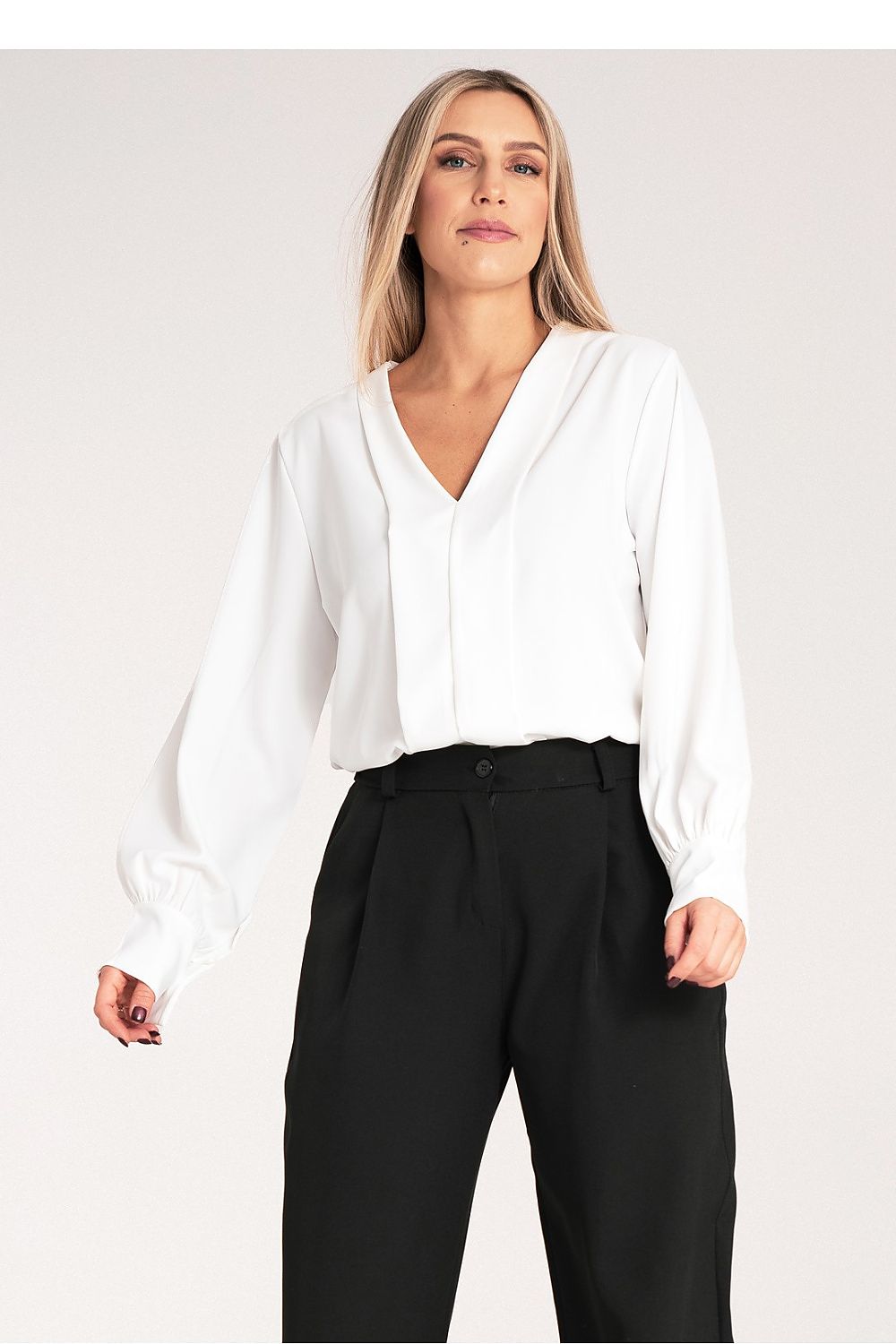 Model wearing the luxury long sleeve satin blouse with V-neckline by Figl, showcasing a stylish and elegant look.