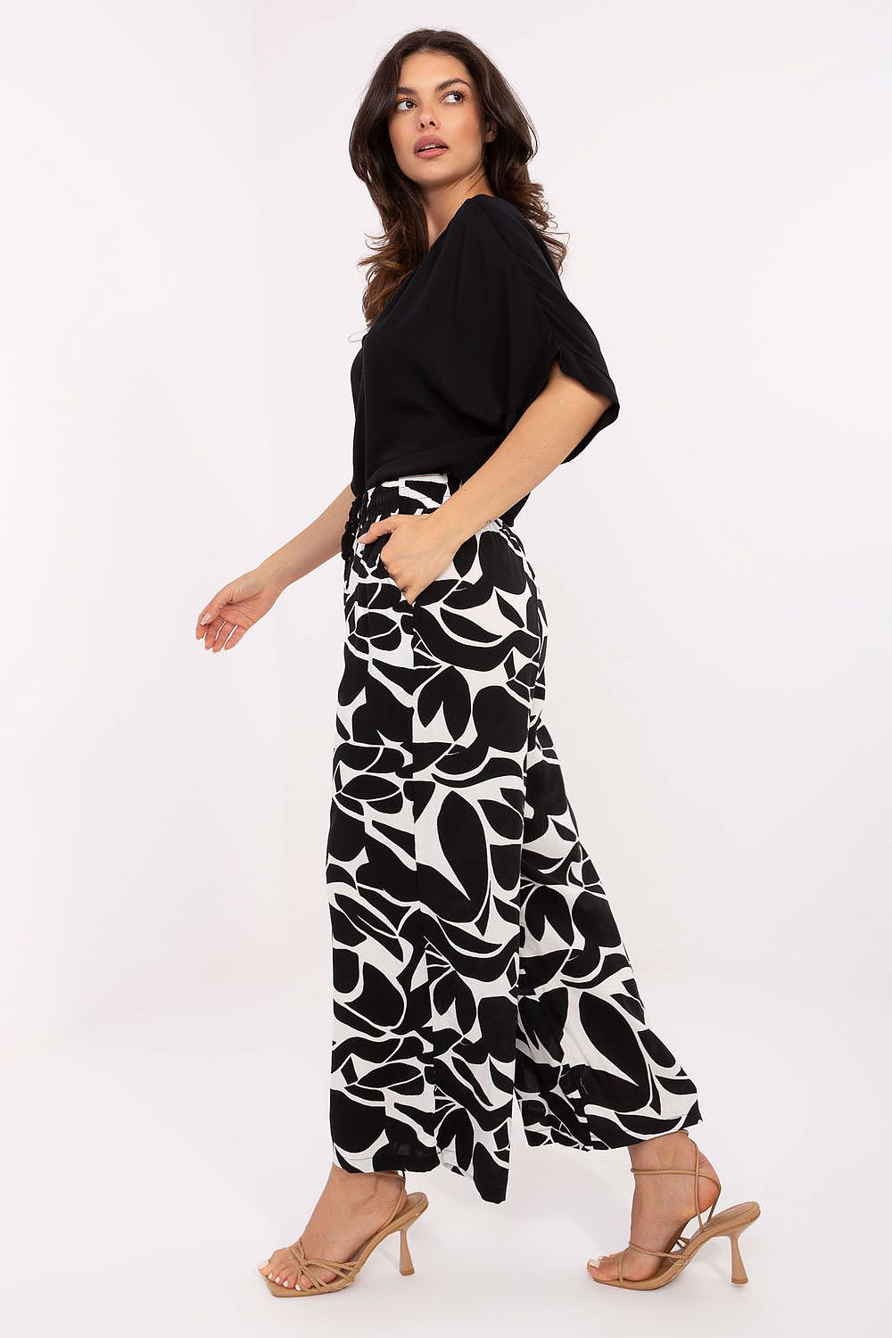 Sublevel Women’s High-Waist Trousers showcased in an idyllic setting, offering a blend of style and eco-conscious fashion for discerning women.