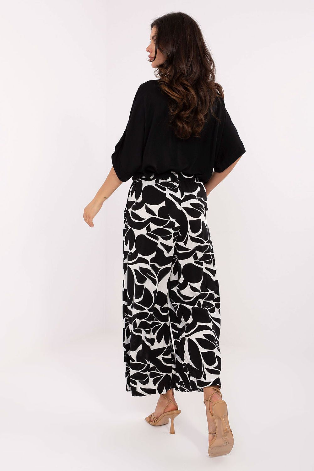 Chic side view of Sublevel Women’s High-Waist Trousers highlighting their wide-leg silhouette and practical side slip pockets.