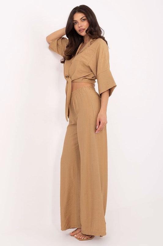 Chic Och Bella women's outfit in breathable fabric; button-up shirt with a tie detail and high-waisted pants, perfect for a stylish, minimalist look.